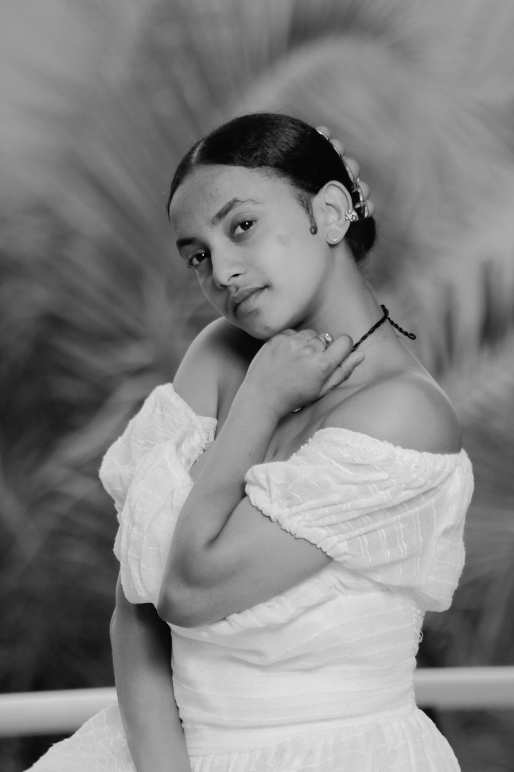 a black and white photo of a woman in a dress