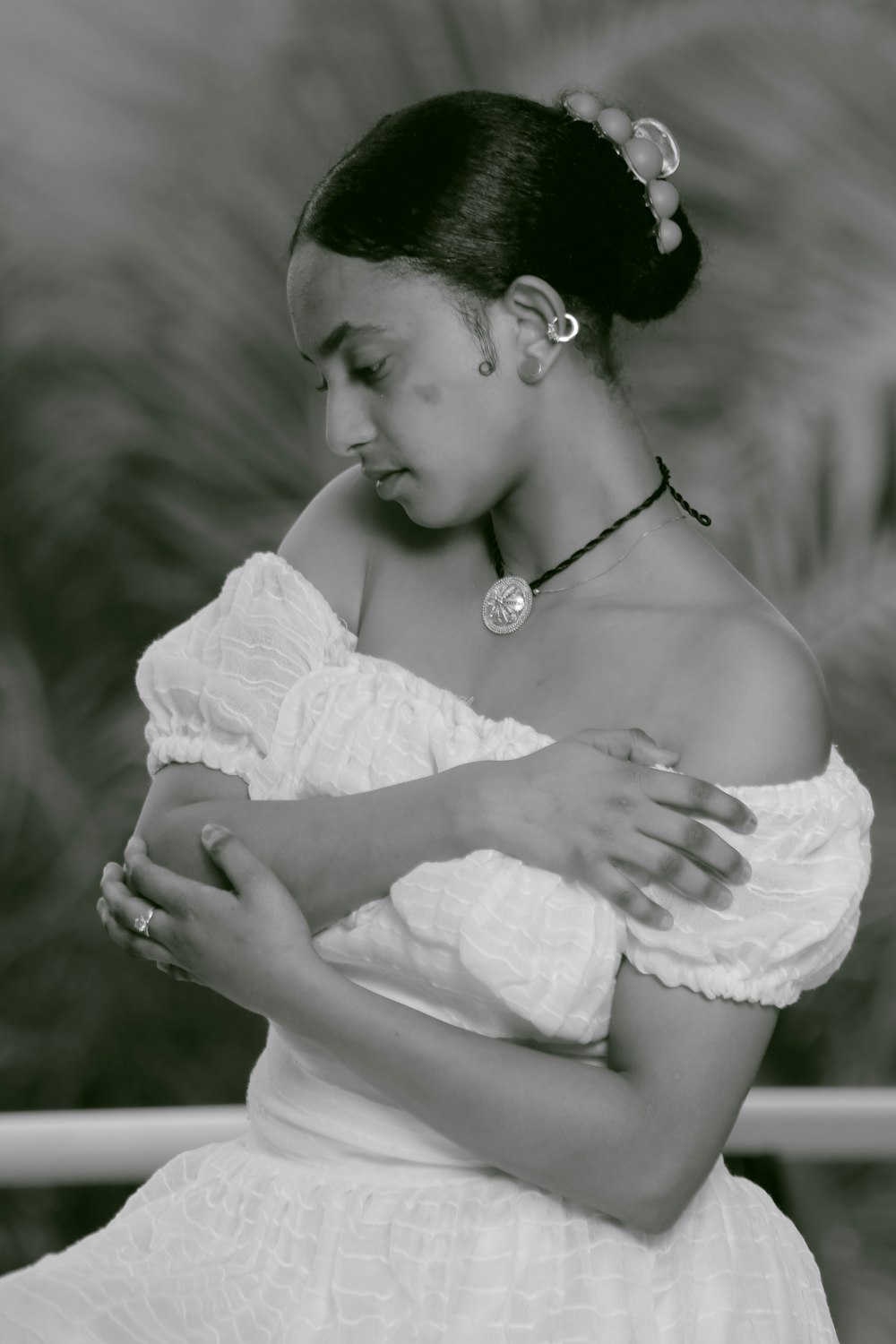 a black and white photo of a woman in a dress