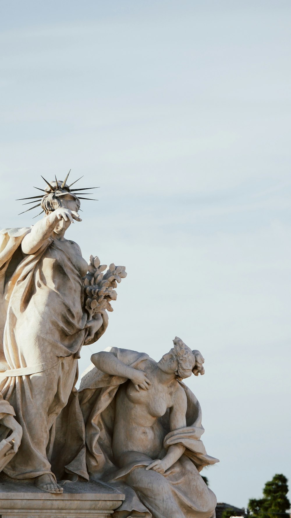 a statue of the statue of liberty surrounded by other statues