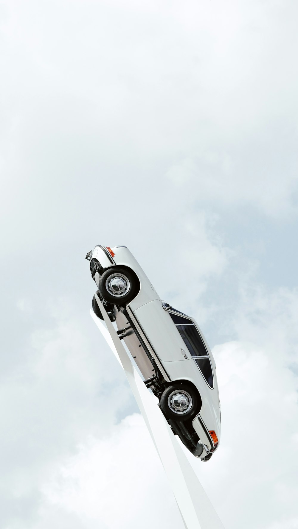 a white car is flying through the air