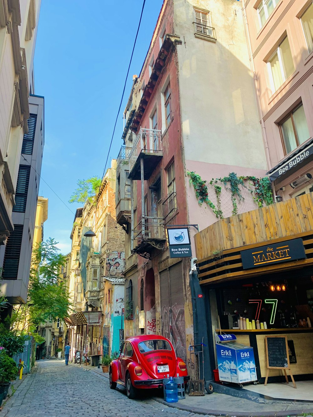 a red car parked on the side of a street