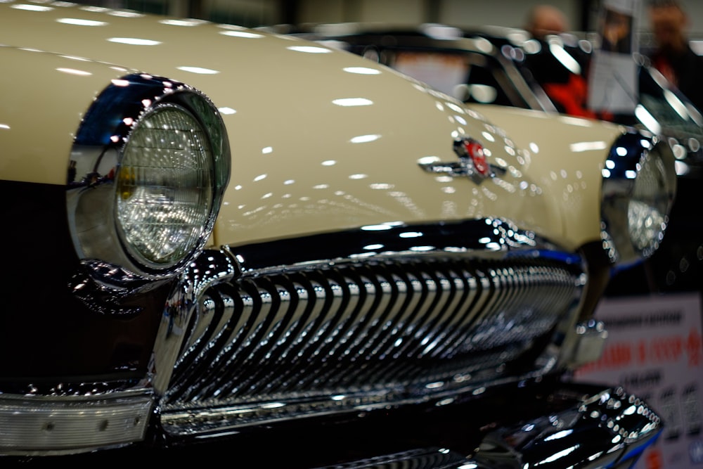 a close up of a car on display at a car show