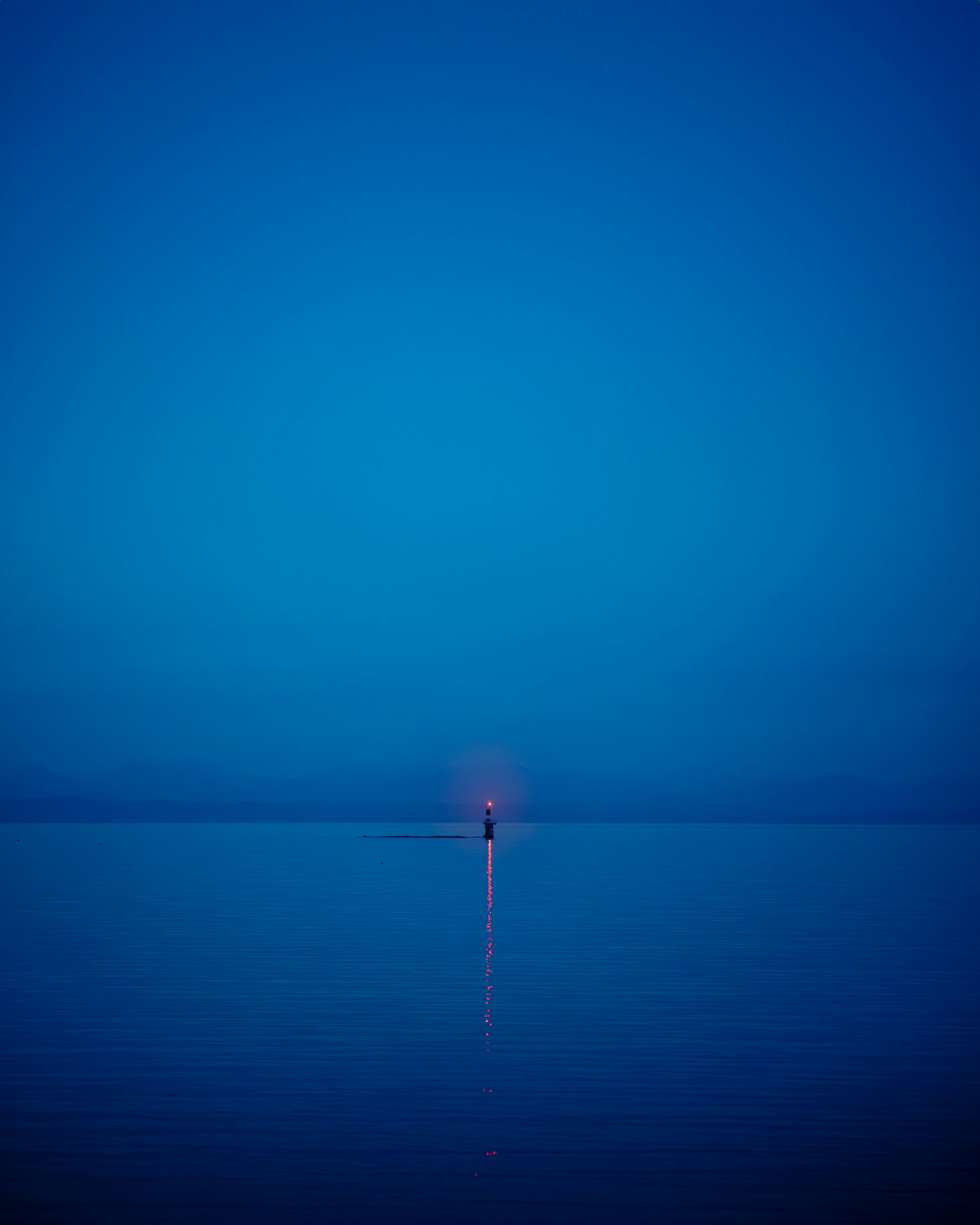 a lone person standing in the middle of a body of water