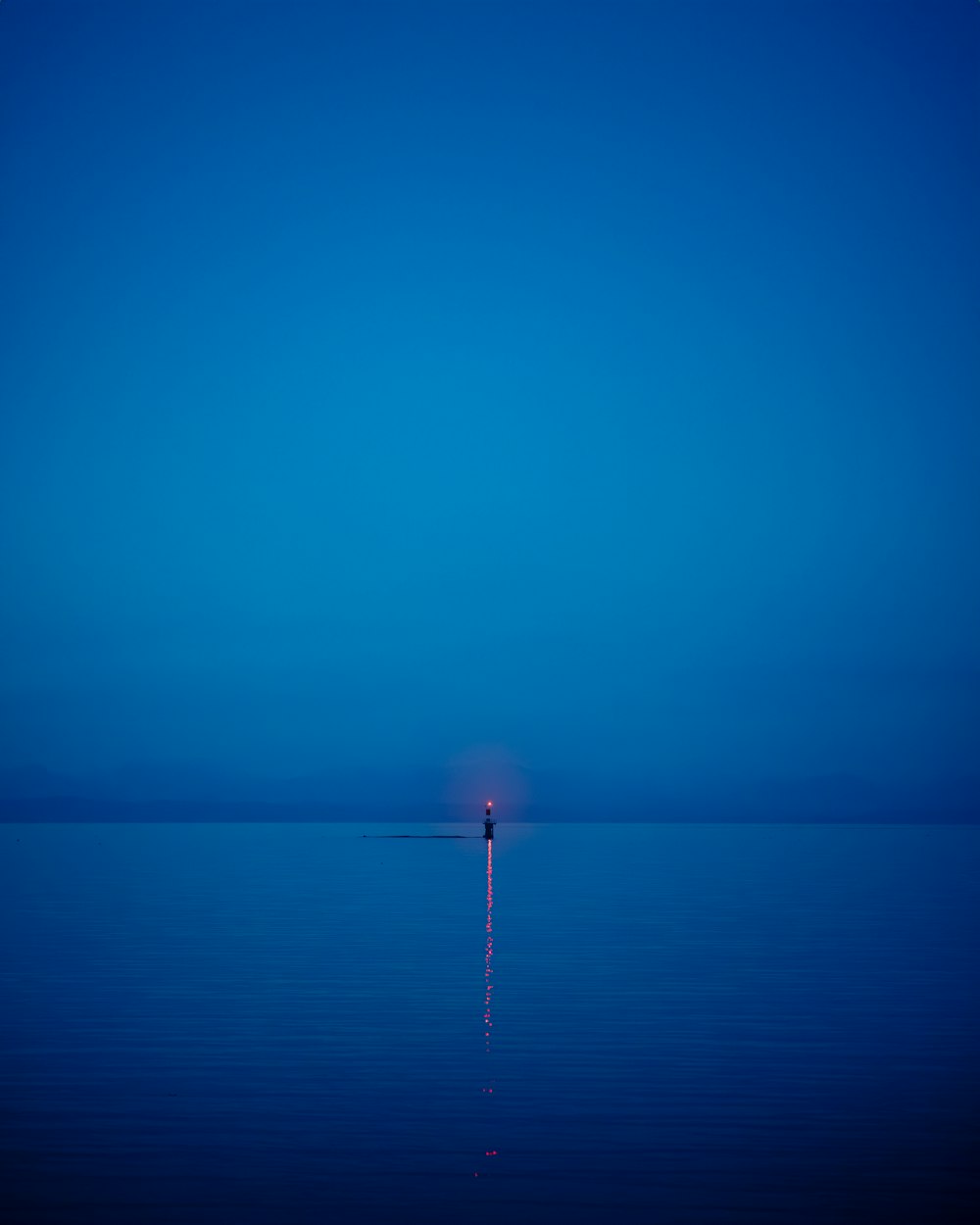 a lone person standing in the middle of a body of water