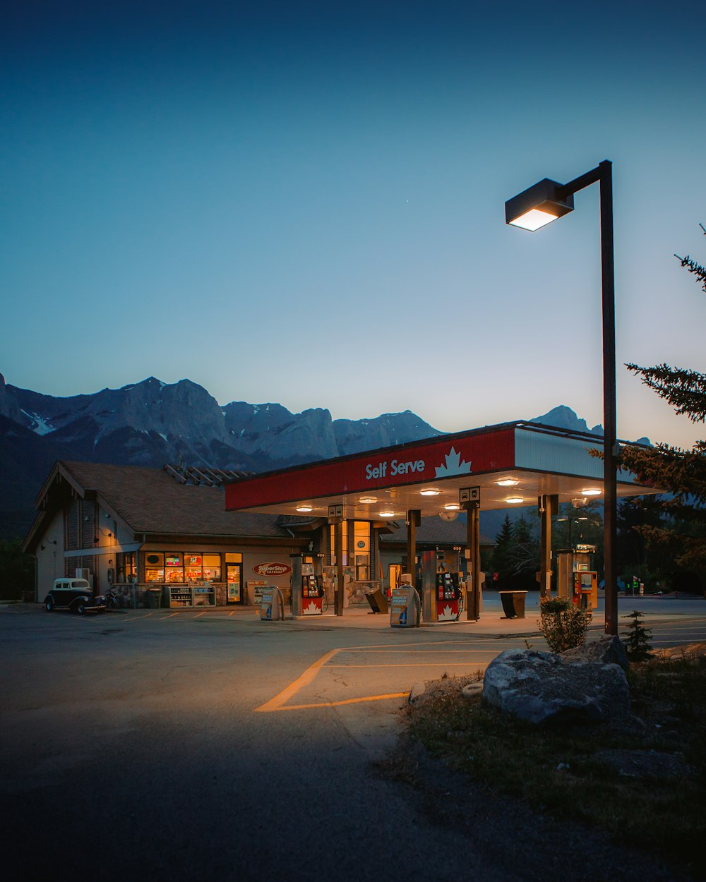 a gas station with mountains in the background