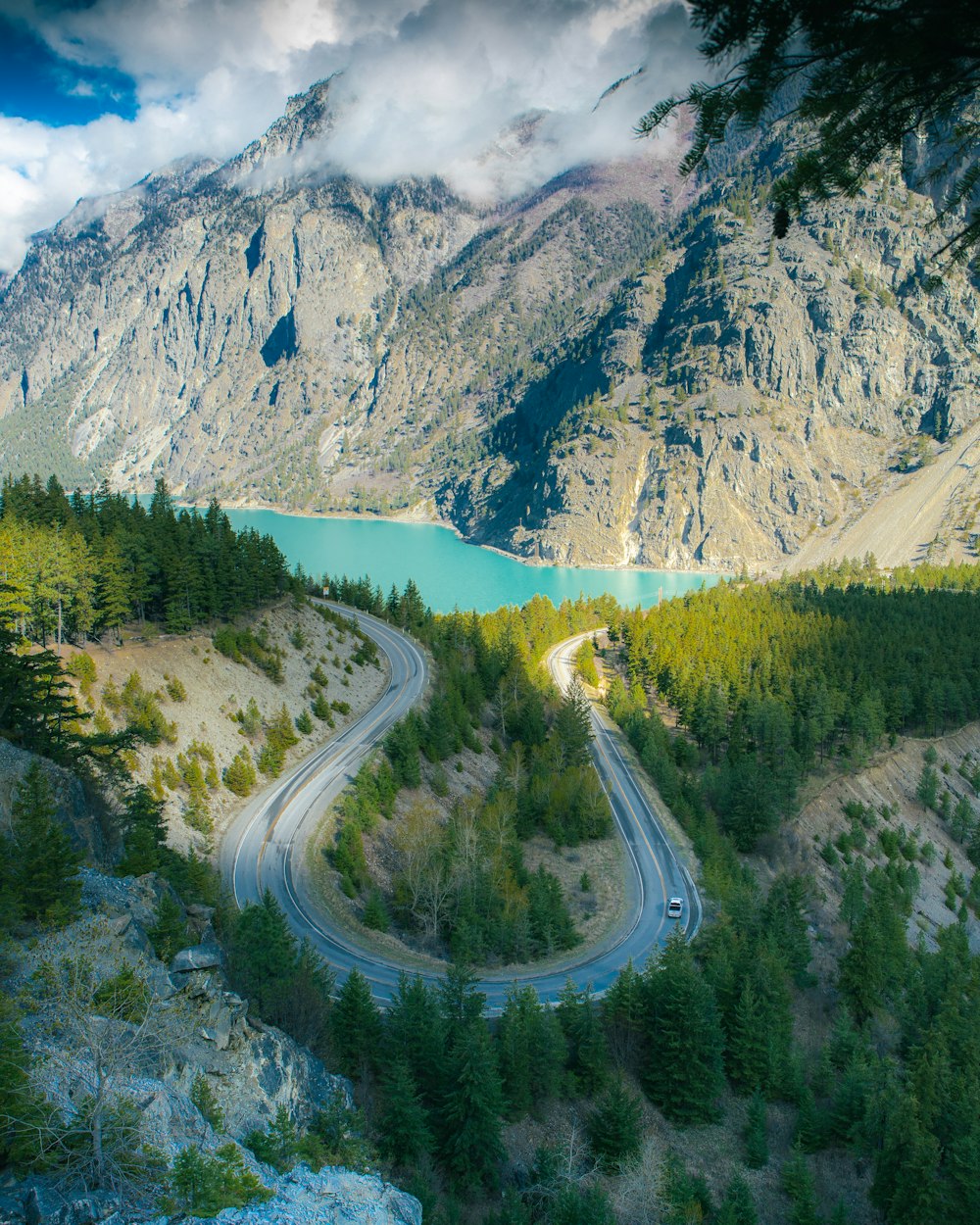 a scenic view of a winding road in the mountains