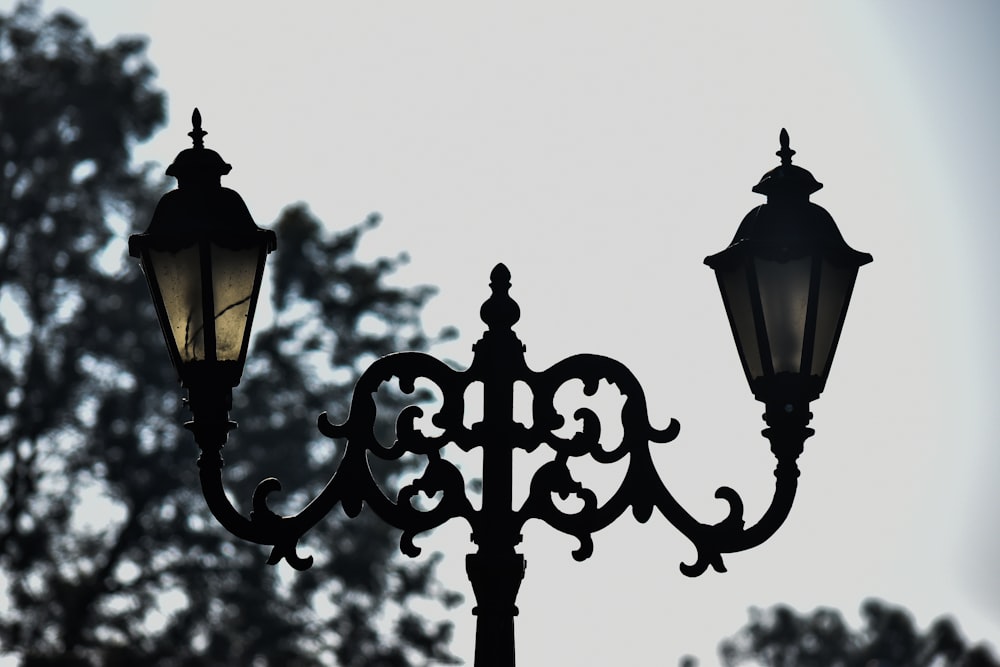 a street light with a tree in the background