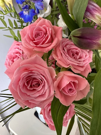 A vibrant bouquet of mixed flowers in bright pink and white tones, styled with delicate greenery.