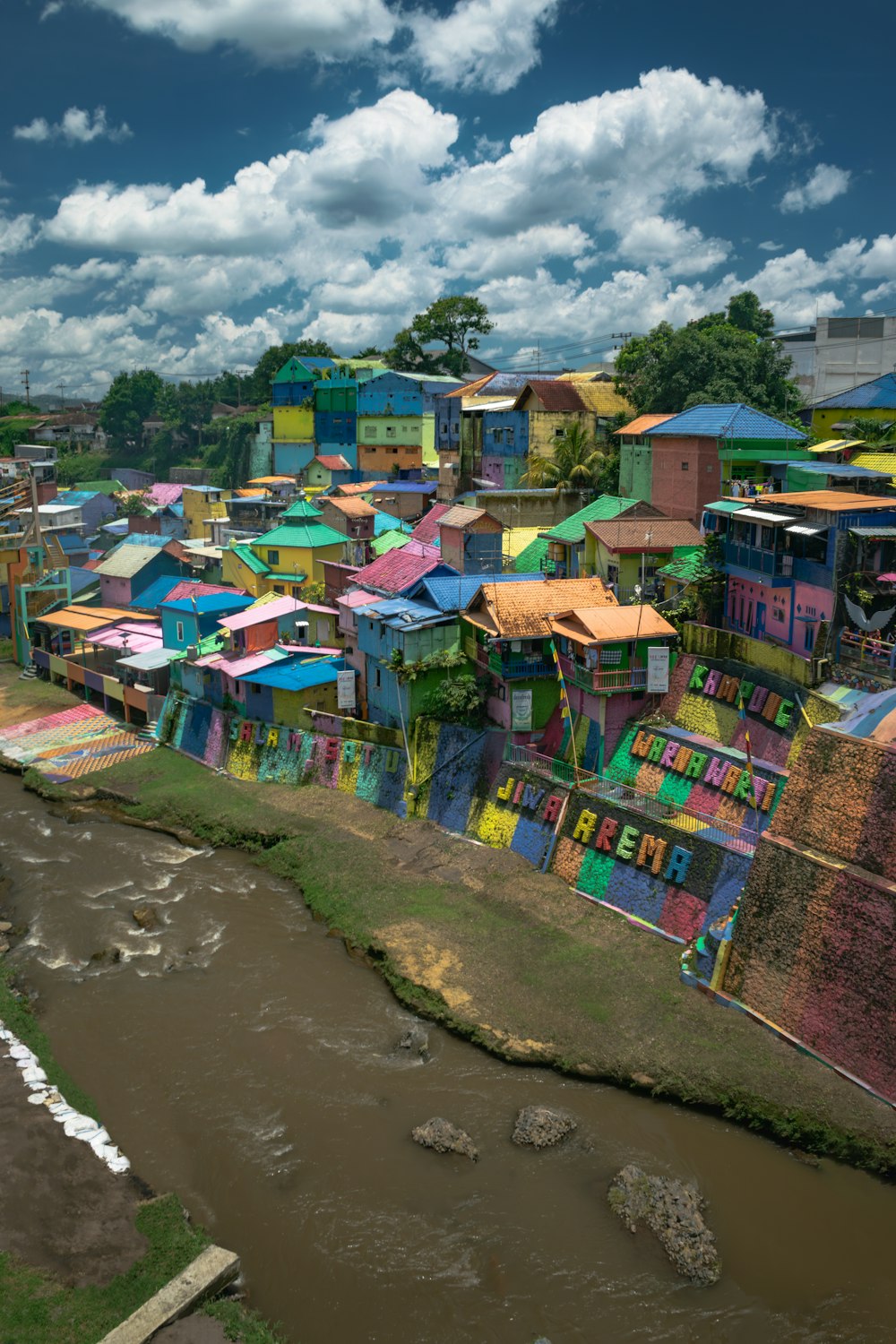a river runs through a city with colorful buildings