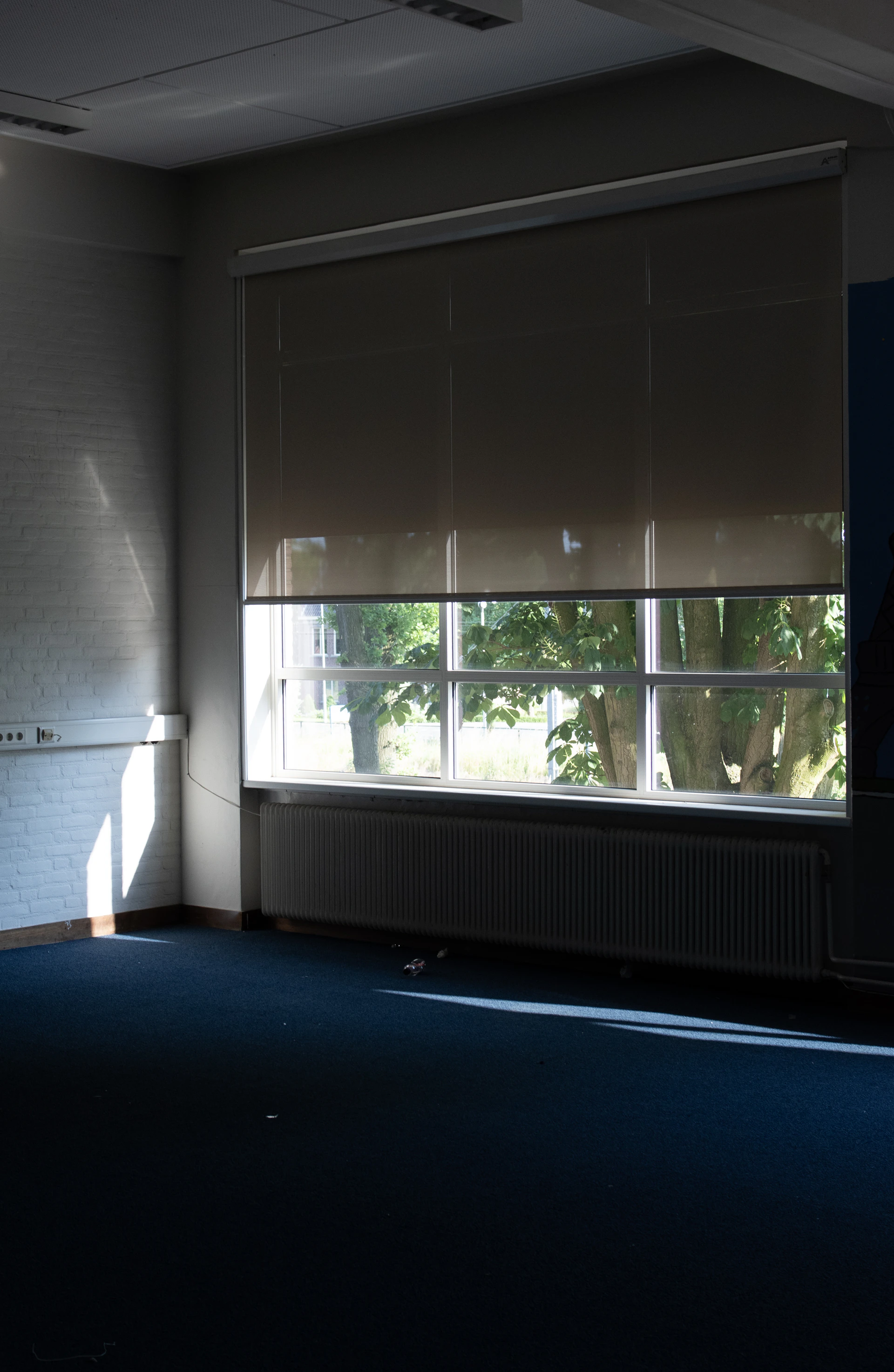 a room with a large window and a radiator