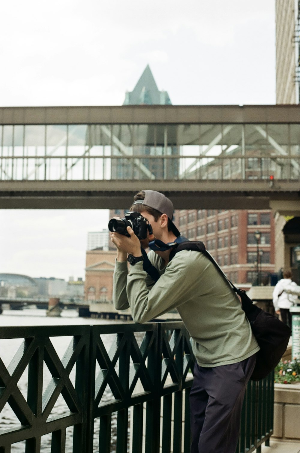 a man taking a picture of a bridge with a camera
