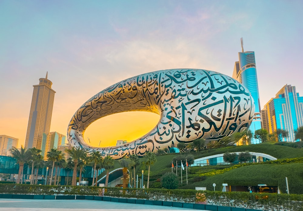 a large sculpture of a whale in front of a cityscape