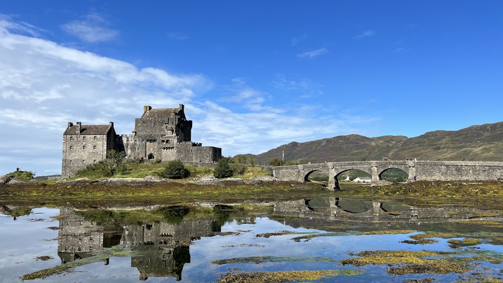 a castle with a bridge over a body of water