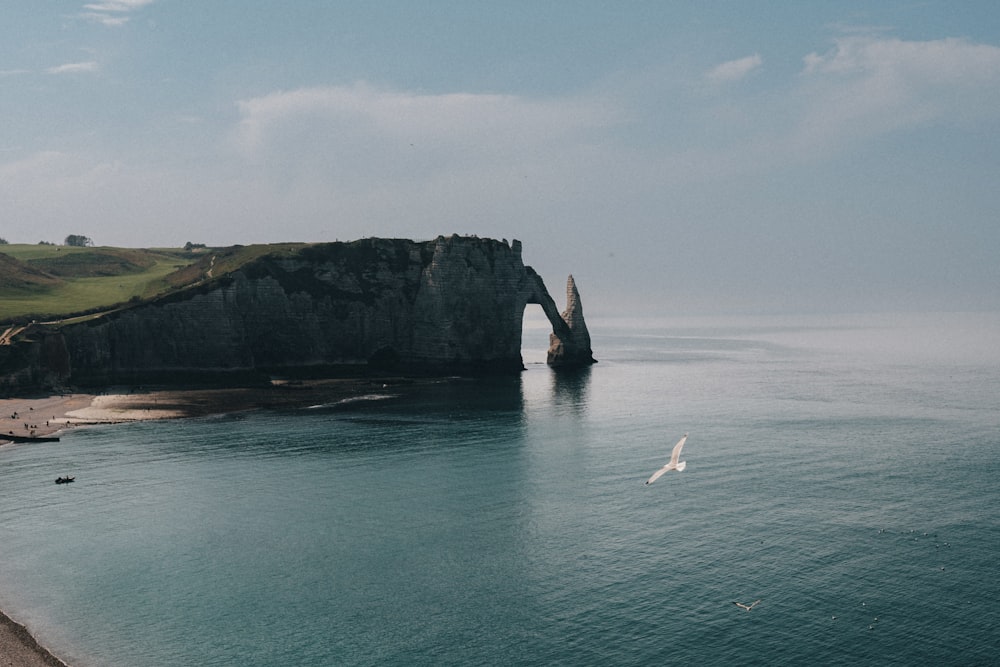 a large body of water with a rock formation in the middle of it