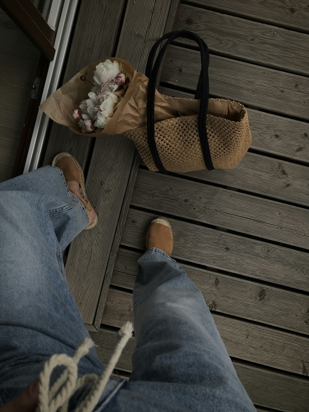 a person standing next to a brown bag