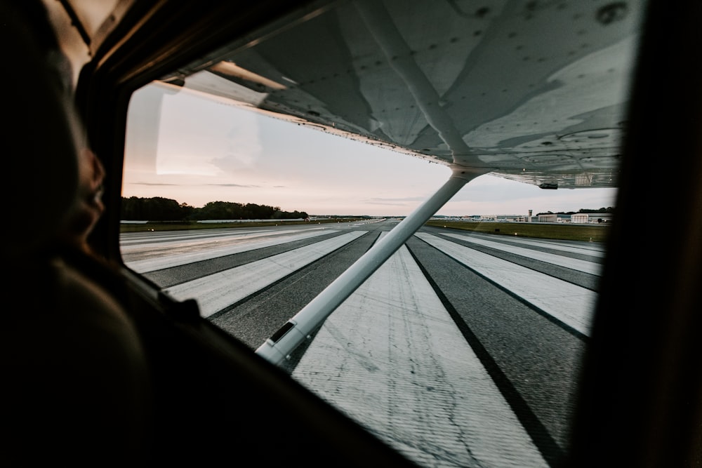 a man is looking out the window of a plane