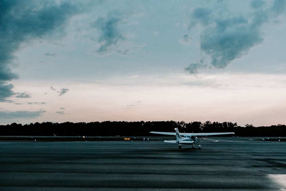 a small plane sitting on top of an airport tarmac