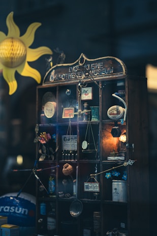 A vintage apothecary cabinet filled with glass bottles and botanical illustrations.