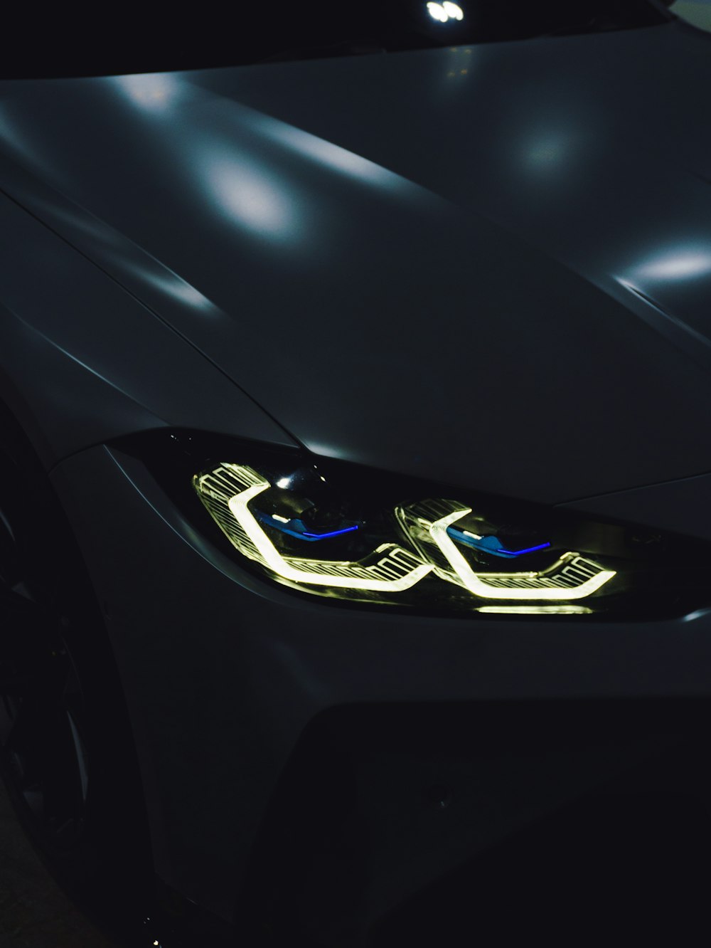 a close up of a car's headlights in the dark