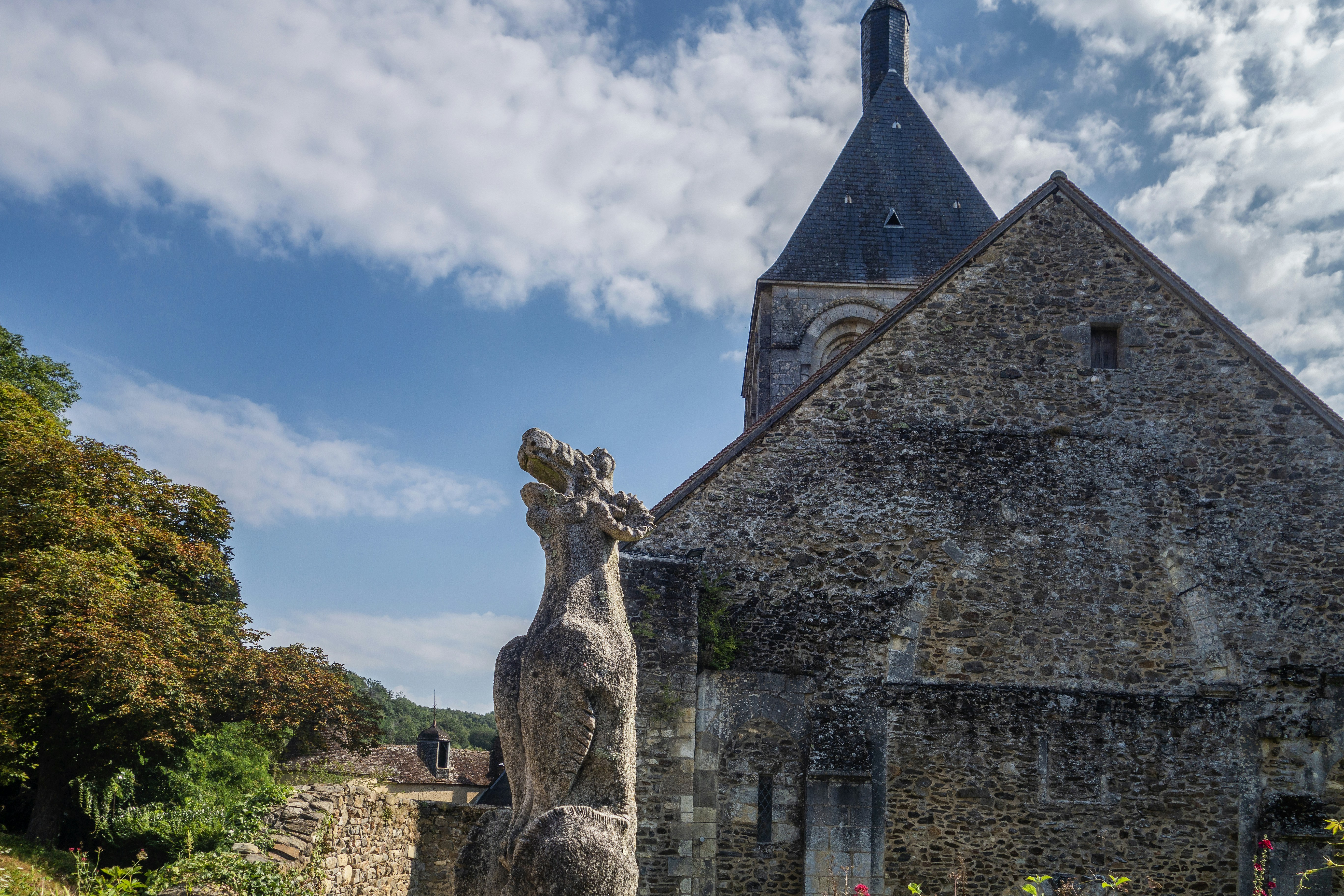 a stone building with a statue of a horse in front of it