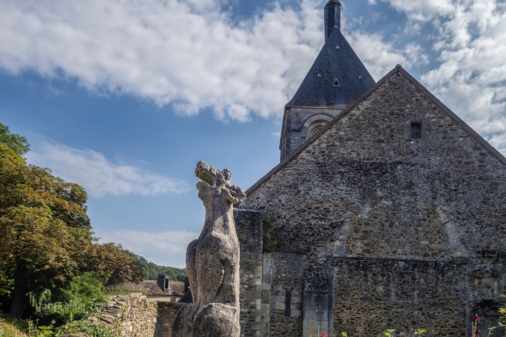 a stone building with a statue of a horse in front of it