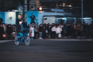 A busy city street with couriers on bicycles delivering parcels.
