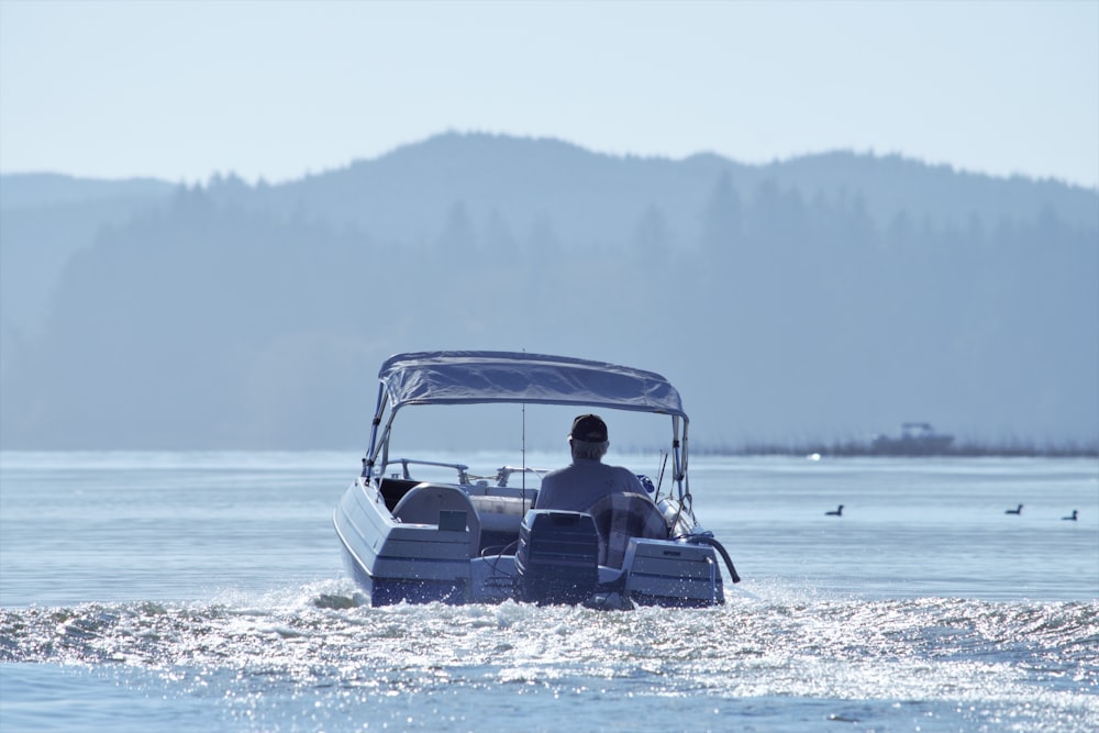 a man driving a boat in the water