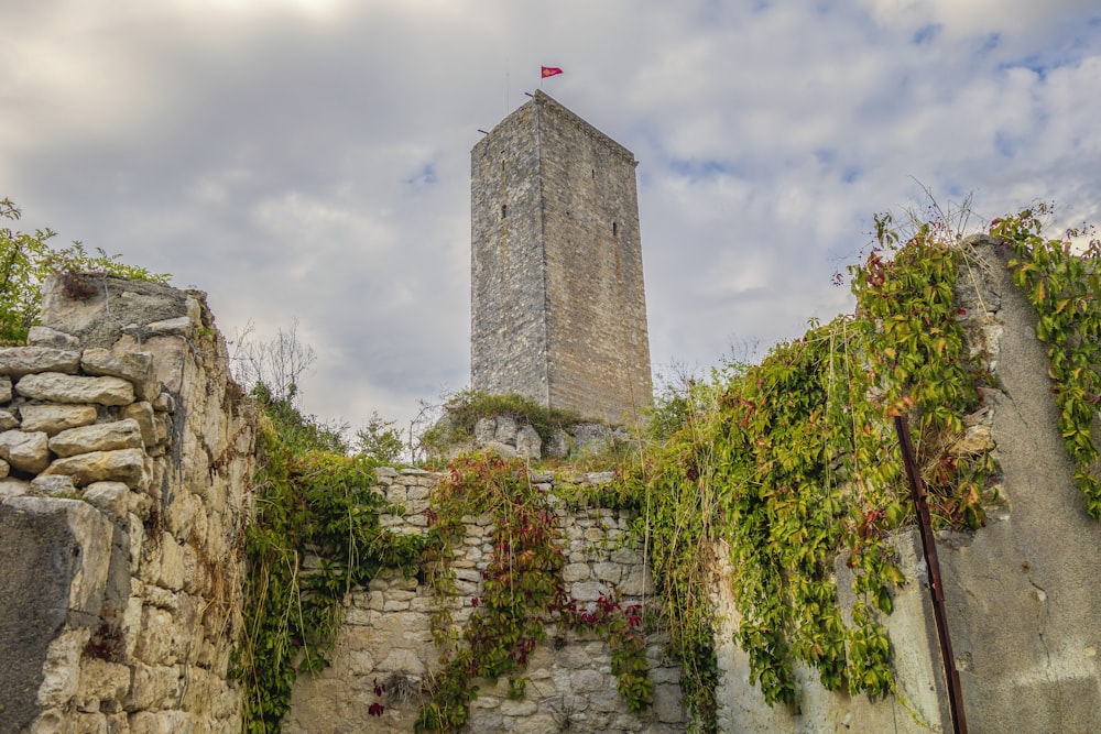 a tall tower with a flag on top of it