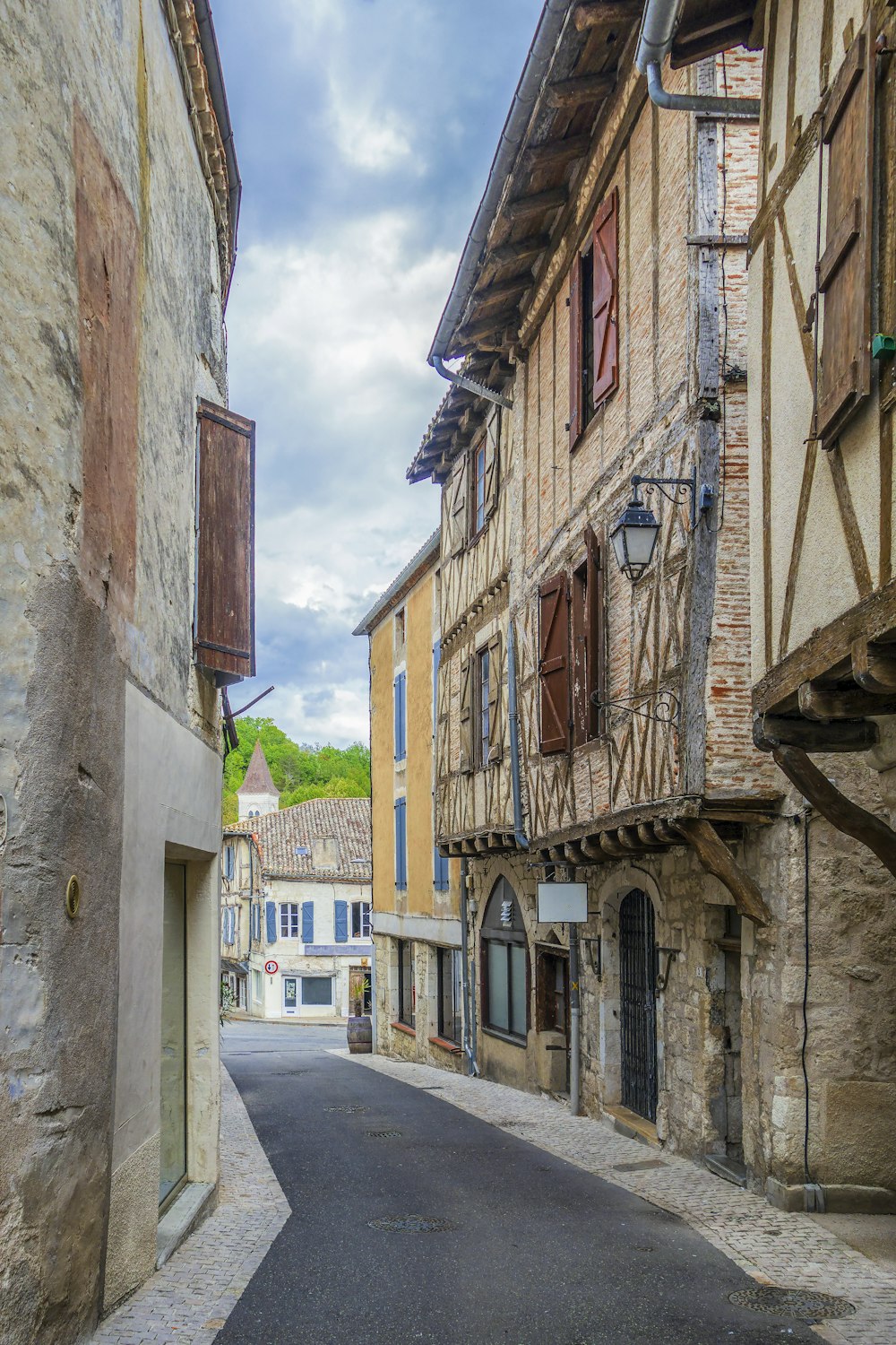 a narrow street lined with stone buildings