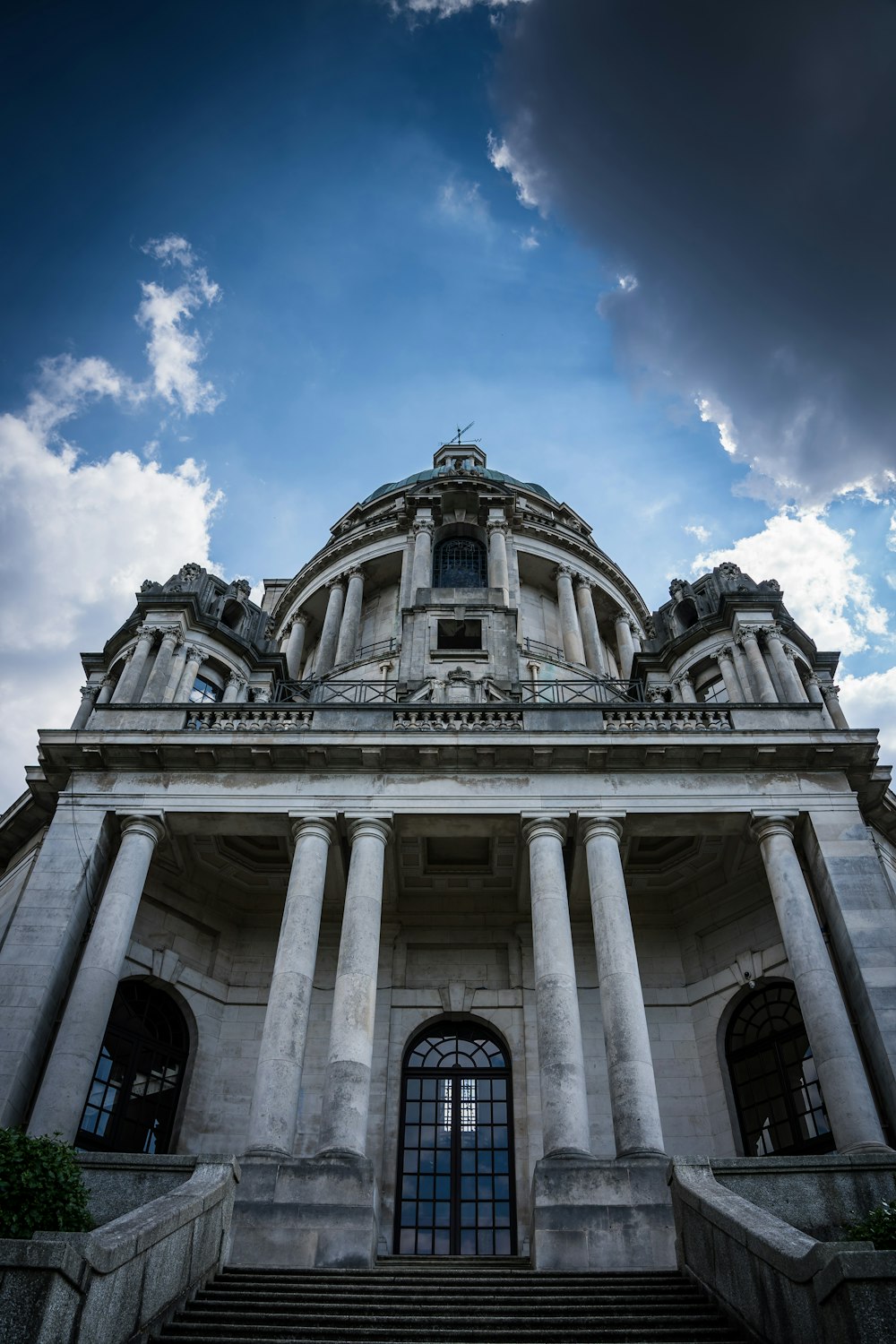 a large building with columns and a sky background