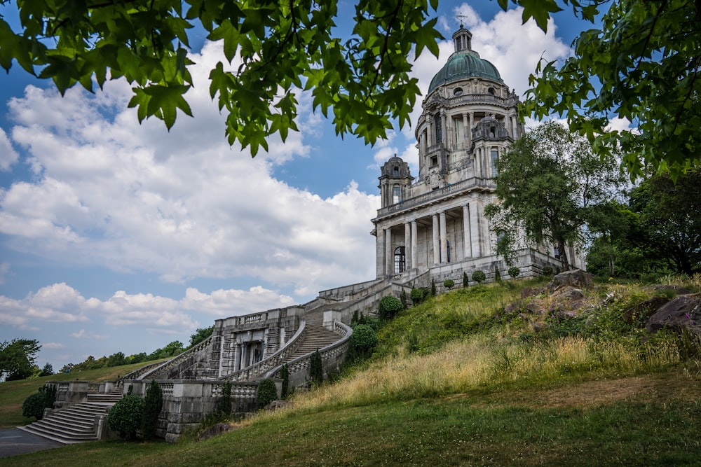 a large building with a steeple on top of a hill