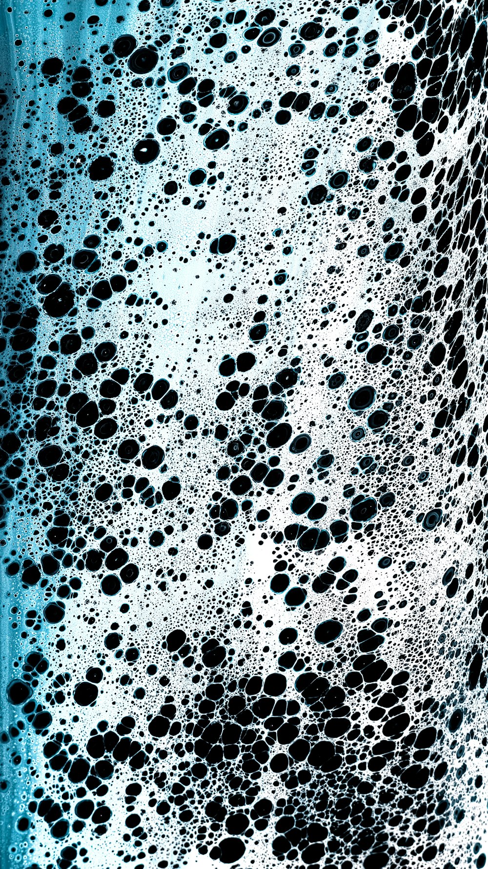 a black and white photo of bubbles in water