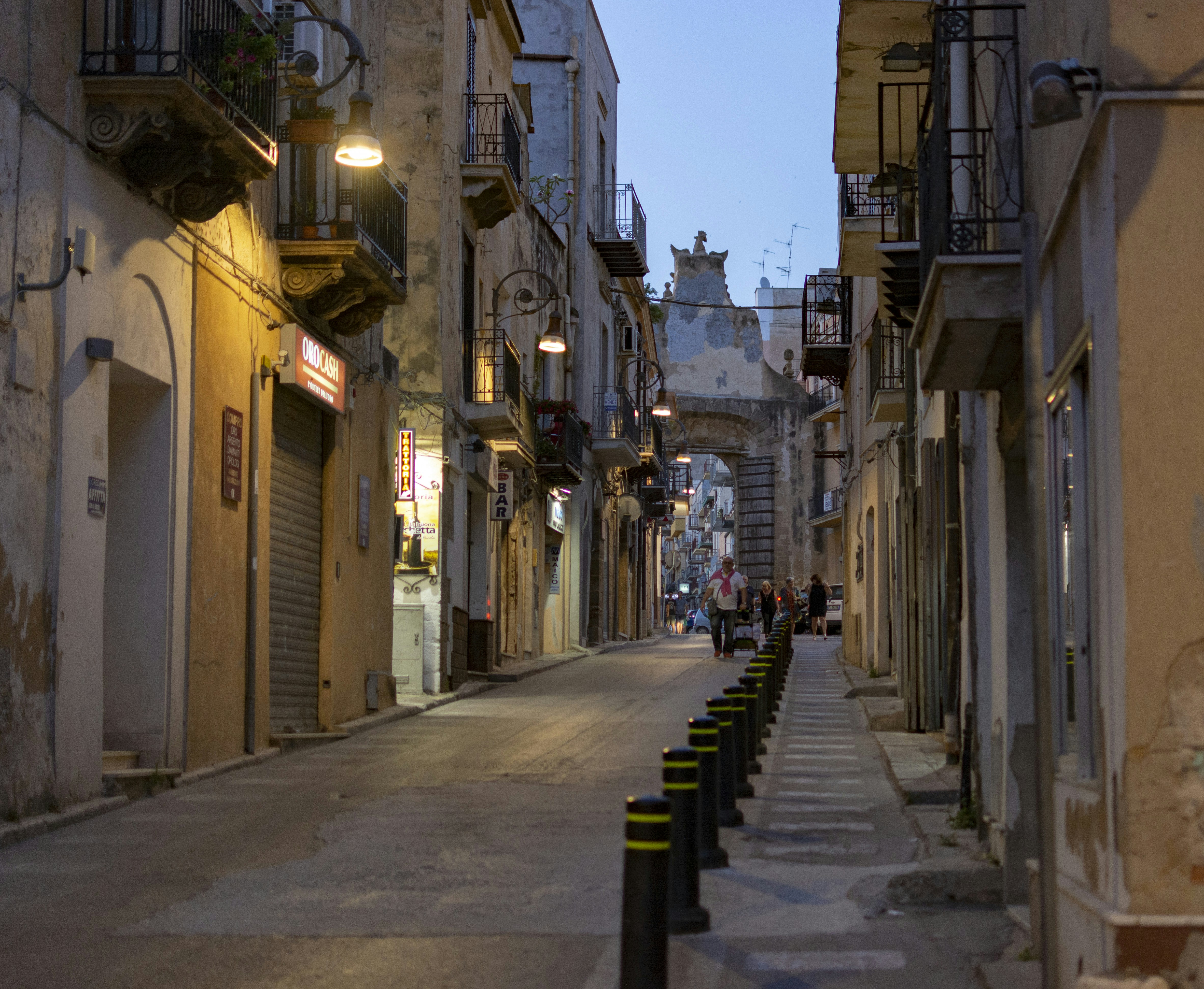 a narrow city street lined with tall buildings