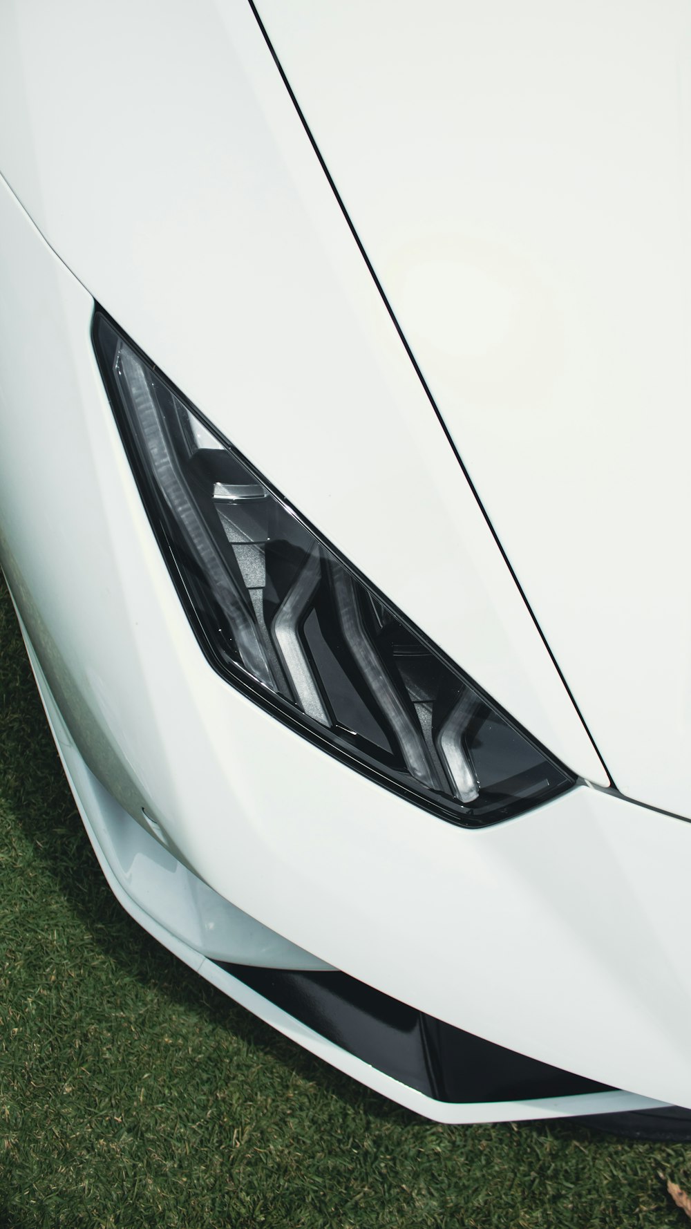 a close up of the front of a white sports car