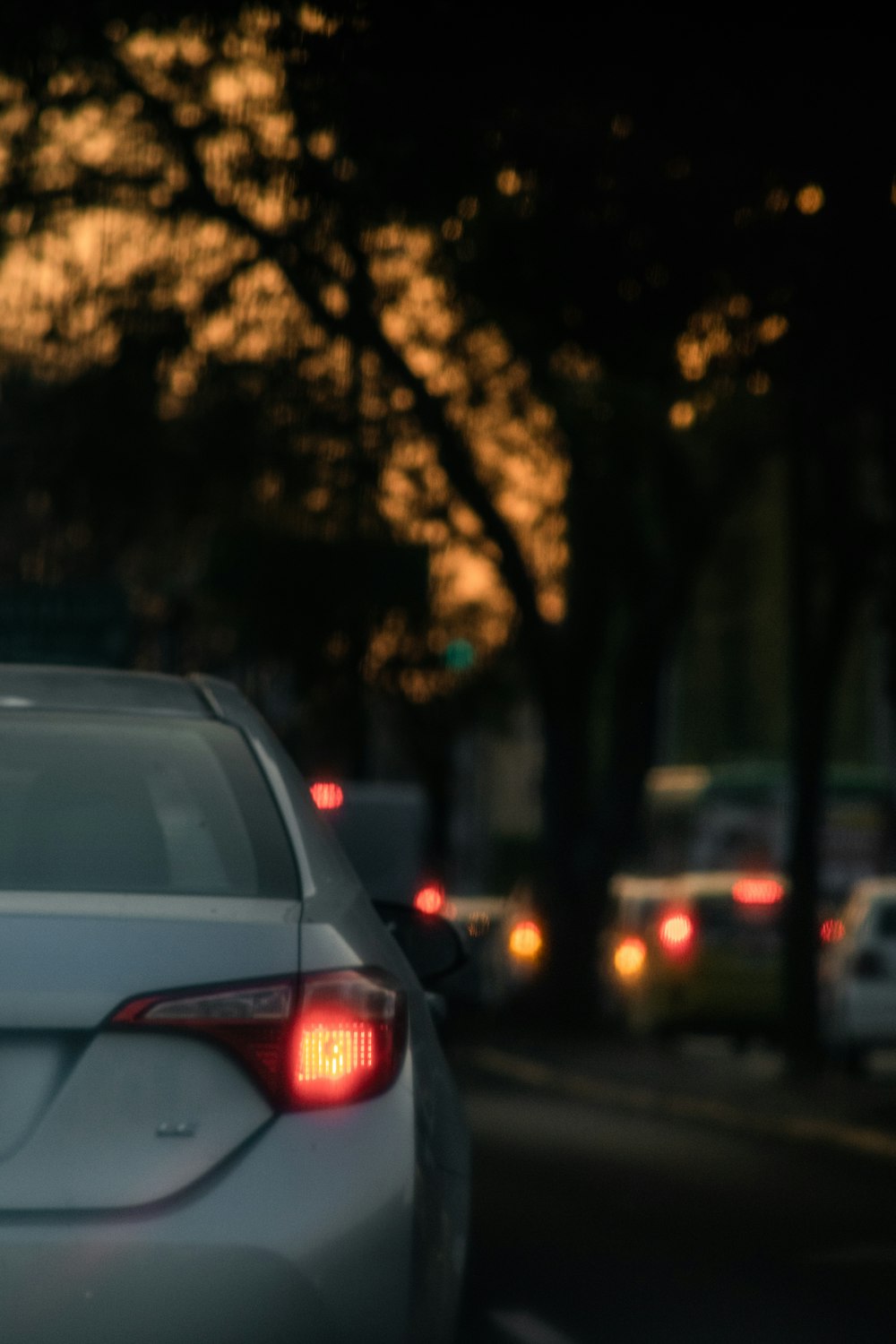 a white car is driving down the street