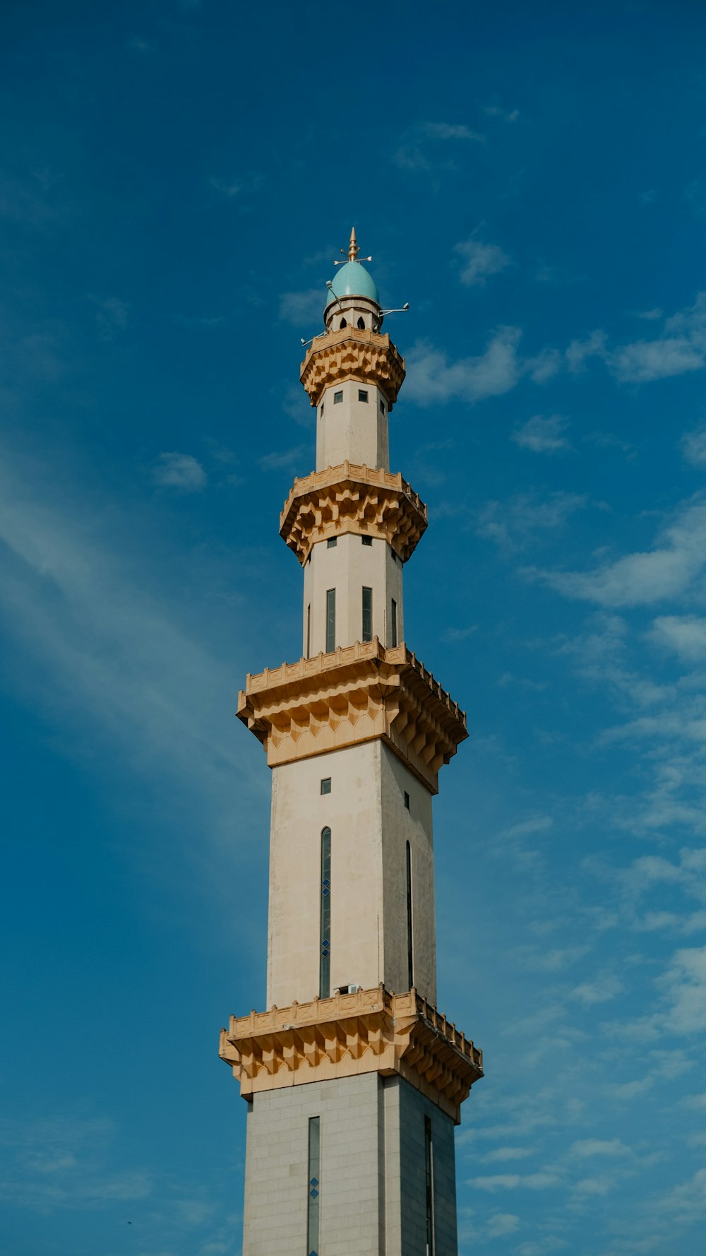 a tall white tower with a blue sky in the background