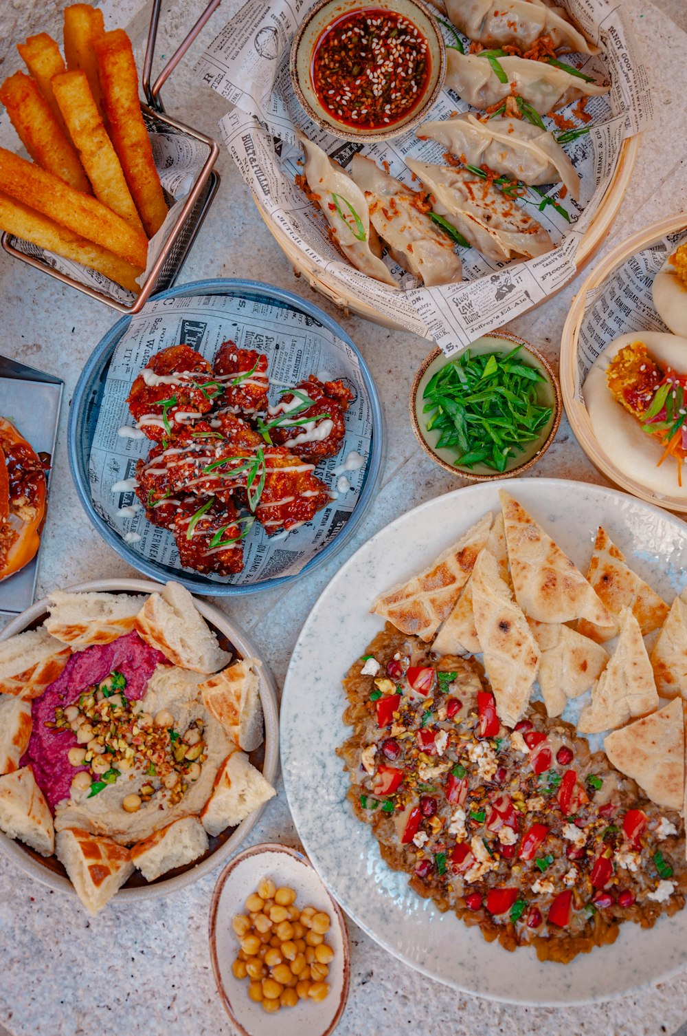 a table topped with lots of plates of food