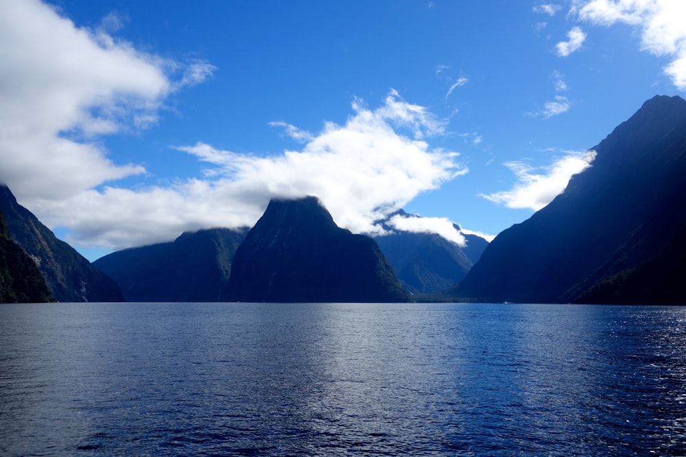 a body of water with mountains in the background