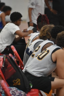 a group of young men sitting next to each other