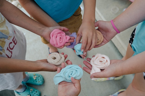 a group of children holding small doughnuts in their hands
