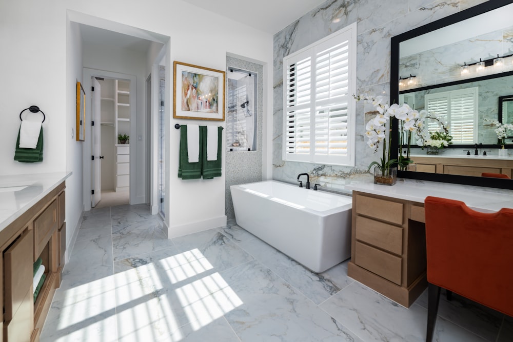 a bathroom with a tub, sink, and mirror