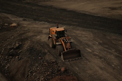 Close-up of a bulldozer’s tracks moving over desert terrain at a Saudi Arabian construction site.