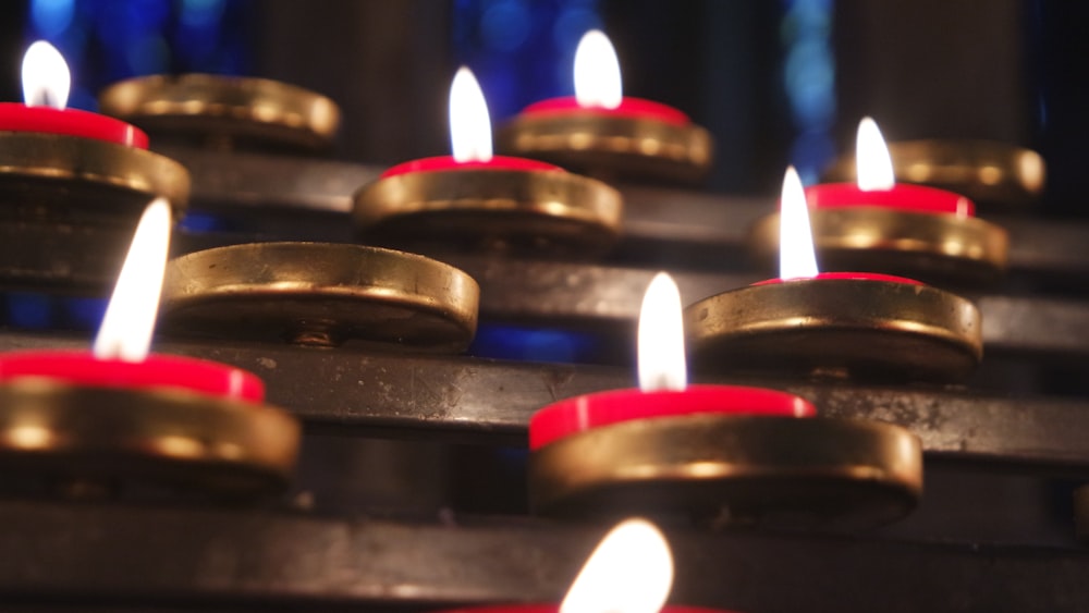 a row of lit candles sitting on top of a table