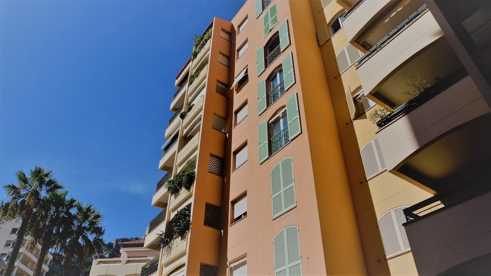 a tall building with palm trees in front of it