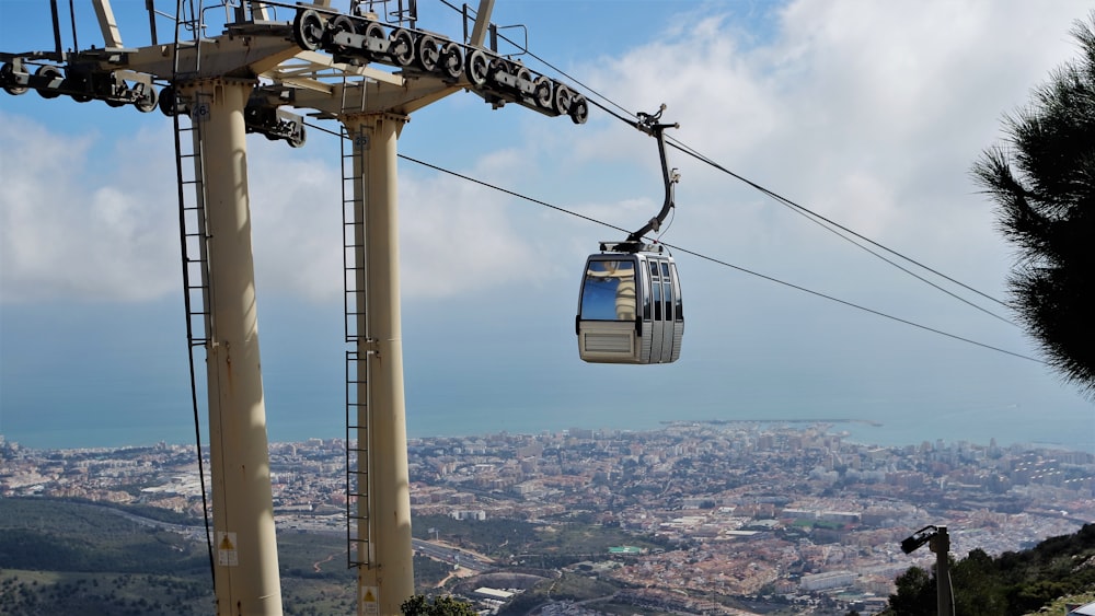 a gondola with a view of a city below