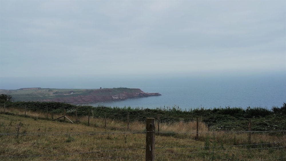 a view of a body of water from behind a fence