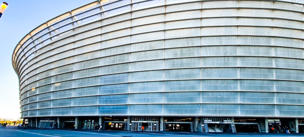 a large round building with a parking lot in front of it