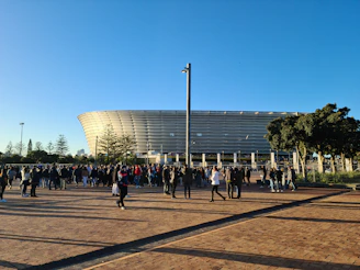 a crowd of people walking around a stadium
