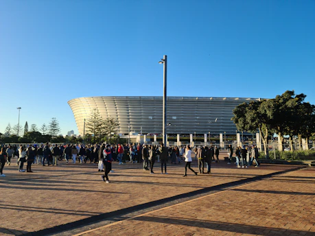 a crowd of people walking around a stadium