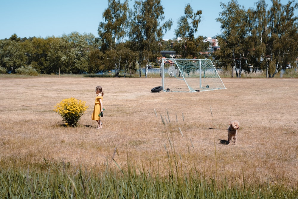 a couple of kids playing a game of frisbee in a field